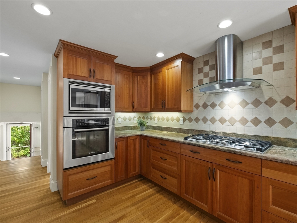 22 Bryant Road Lexington, MA 02420 - Photo 10 of 40 a kitchen with stainless steel appliances granite countertop a stove a sink and a microwave
