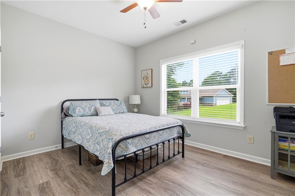 302 Spence Circle Ball Ground, GA 30107 - Photo 30 of 55 a bed sitting in a bedroom next to a window