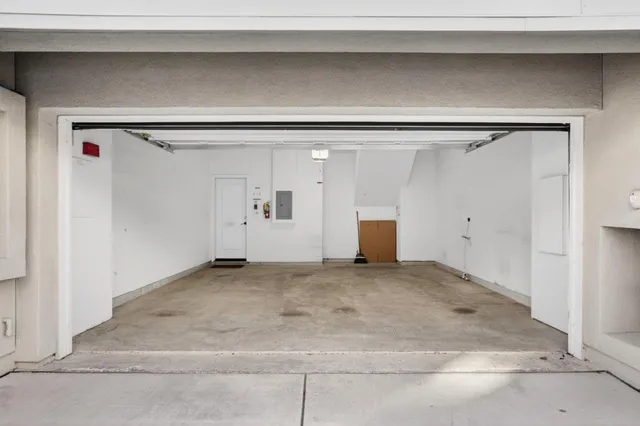 a view of a patio with couple of chairs and a potted plant