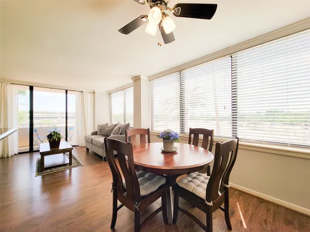 a dining room with furniture window and wooden floor