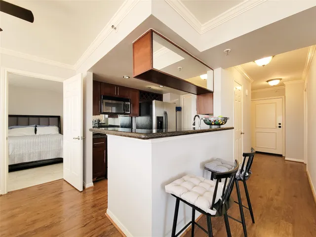 a kitchen with stainless steel appliances kitchen island granite countertop a sink and cabinets