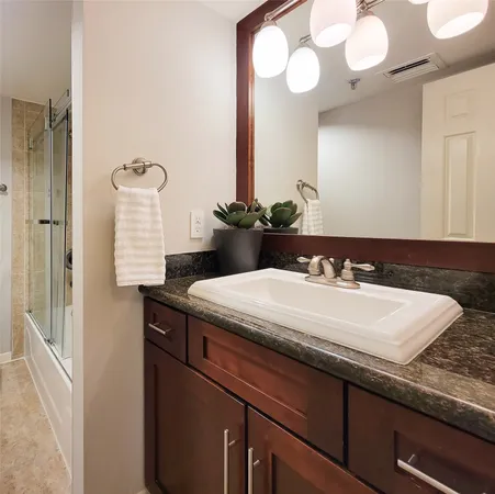 a bath tub sitting next to a white sink
