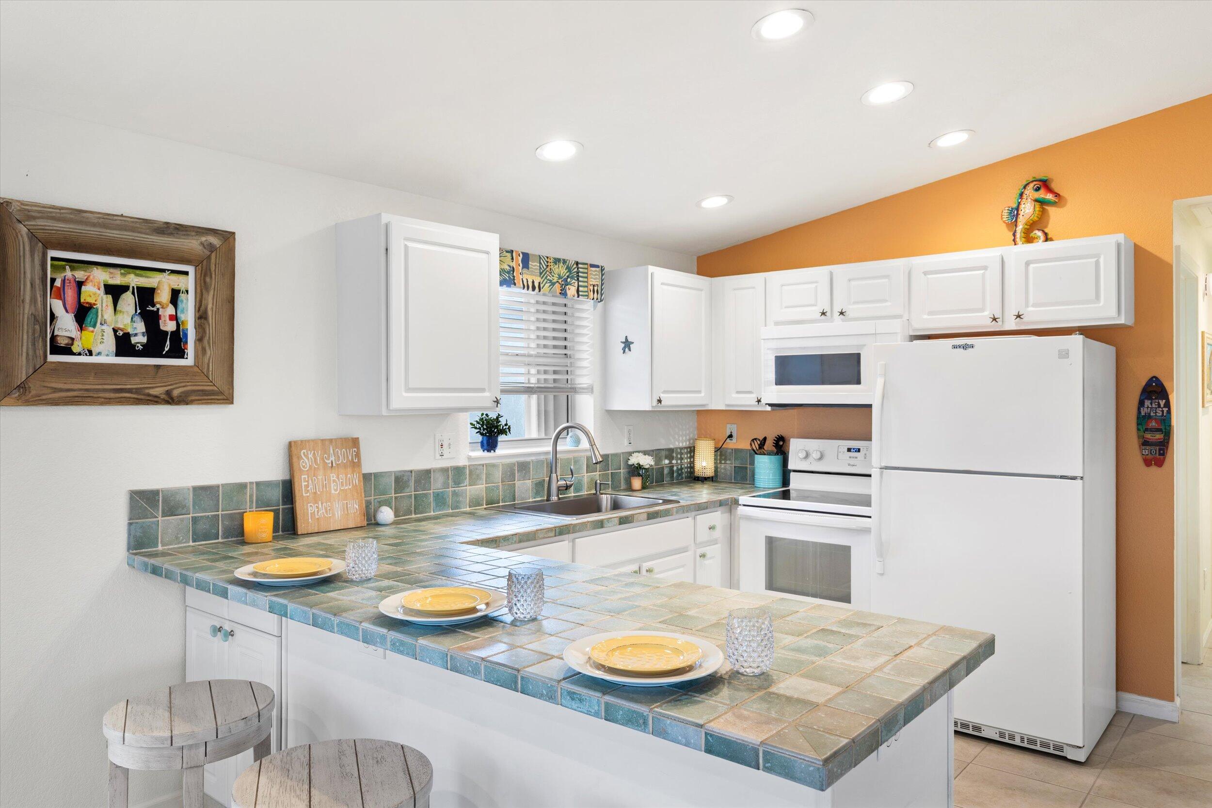 157 Mars Lane Key West, FL 33040 - Photo 17 of 41 a kitchen with a sink a stove and refrigerator