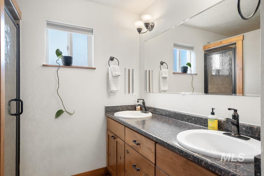 417 East E Street Moscow, ID 83843 - Photo 16 of 29 Bathroom with double vanity and baseboards