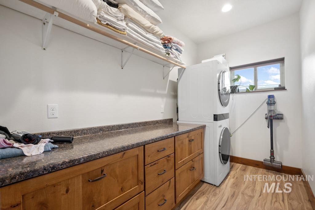 417 East E Street Moscow, ID 83843 - Photo 18 of 29 Washroom with light wood finished floors, estacked washer and dryer, and recessed lighting