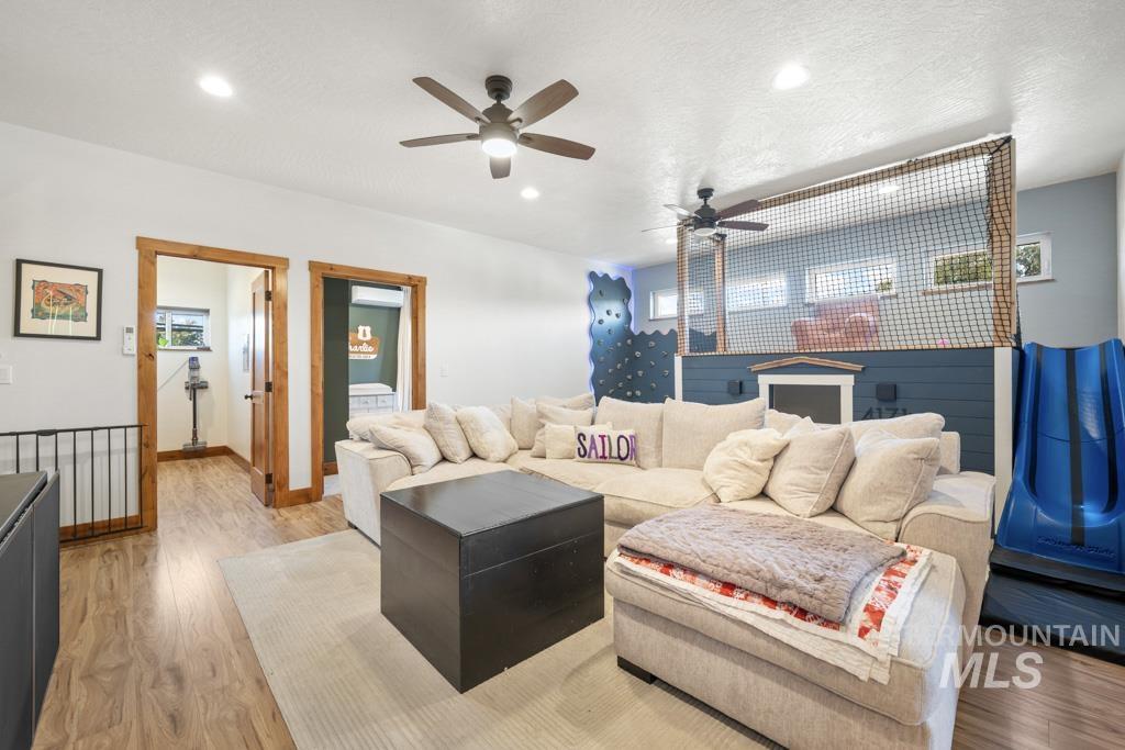 417 East E Street Moscow, ID 83843 - Photo 22 of 29 Living area with wood finished floors, recessed lighting, a textured ceiling, plenty of natural light, and ceiling fan