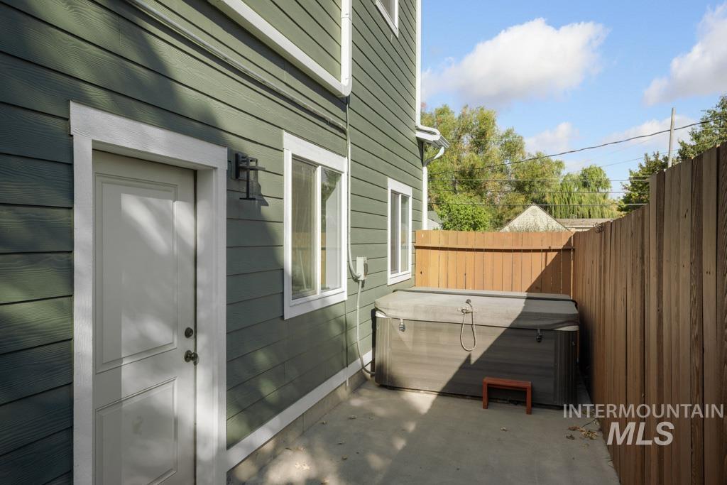 417 East E Street Moscow, ID 83843 - Photo 26 of 29 View of side of home featuring a hot tub, a patio, and a fenced backyard