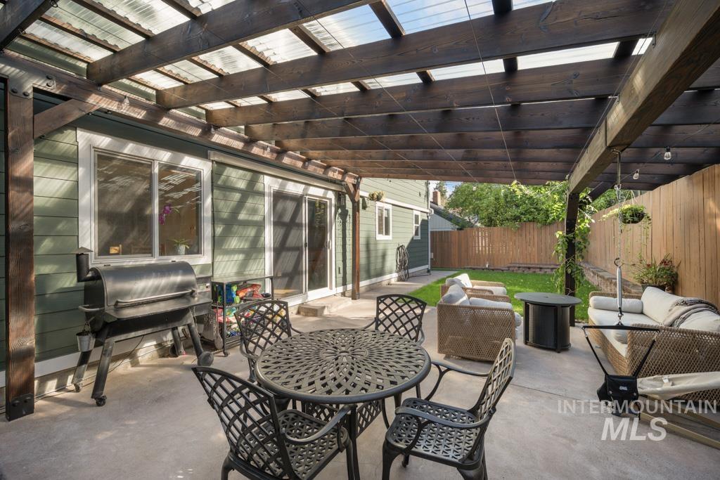 417 East E Street Moscow, ID 83843 - Photo 28 of 29 Fenced backyard featuring a grill, a patio, and an outdoor hangout area