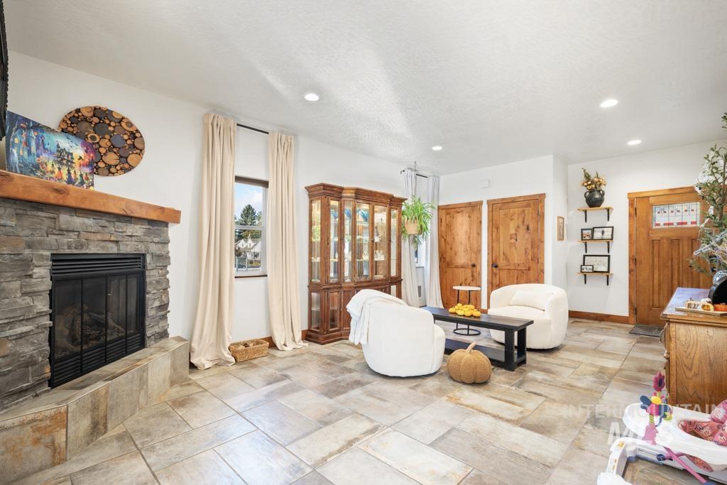 417 East E Street Moscow, ID 83843 - Photo 5 of 29 Living room with a stone fireplace and recessed lighting