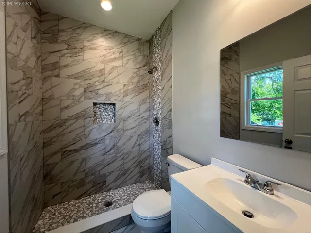 a bathroom with a sink toilet and shower