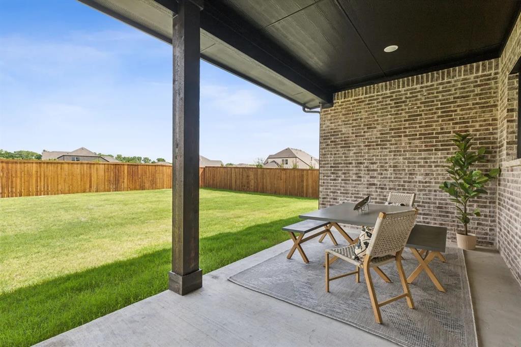 1310 Benjamin Trail Van Alstyne, TX 75495 - Photo 26 of 27 Fenced backyard featuring a patio and outdoor dining area