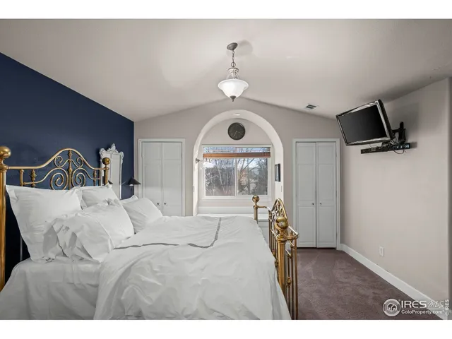 a bedroom with a bed and a mirror