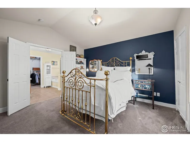 a bed room with a bed and a chair