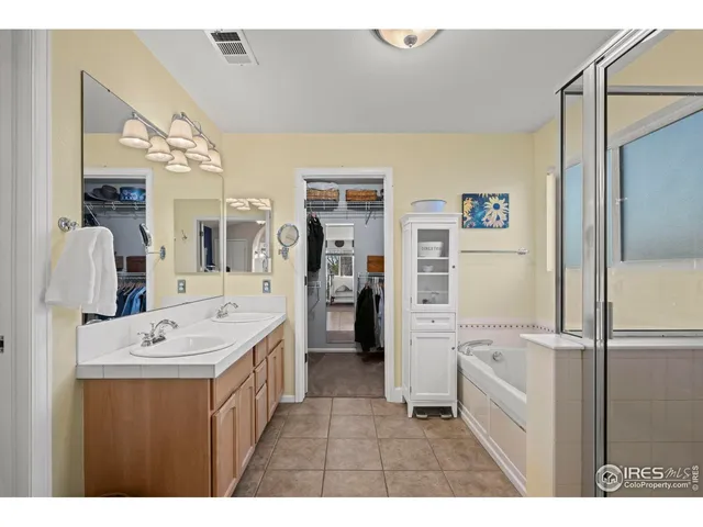 a bathroom with a sink a mirror and a shower