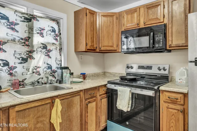 a kitchen with stainless steel appliances granite countertop a sink and a stove