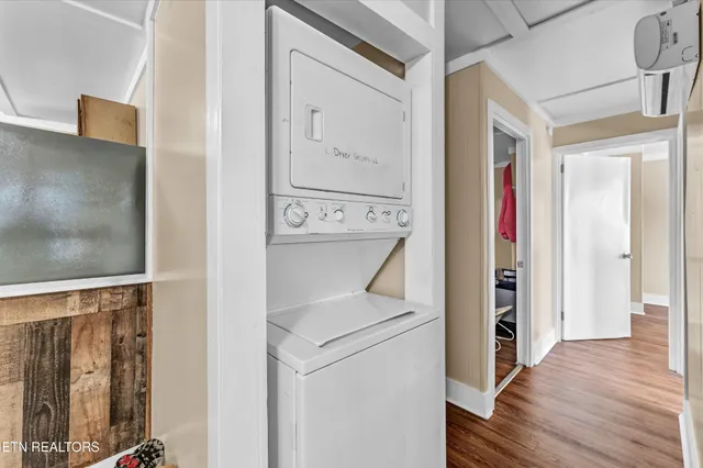a view of bathroom with a bathtub and a wooden floor