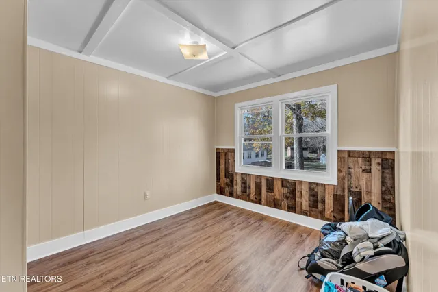 a view of a room with wooden floor and windows