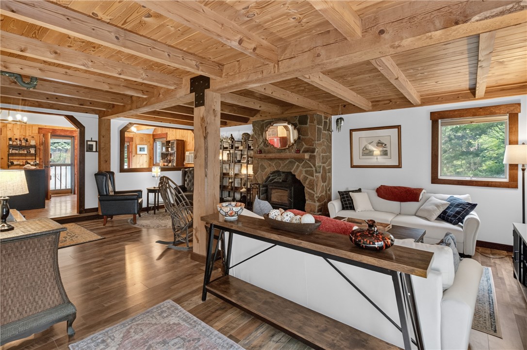 130 Maggie Rufus Lane Westminster, SC 29693 - Photo 32 of 50 Exposed wooden beams and a stone fireplace create a welcoming, rustic ambiance in this living space.
