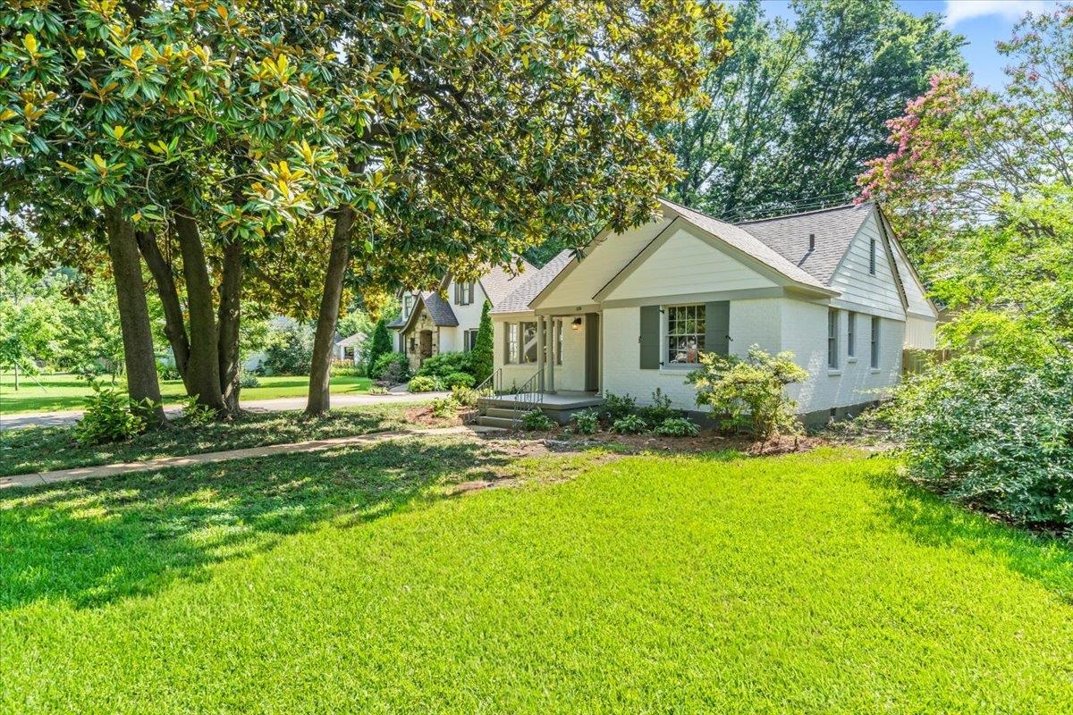 170 South Greer Street Memphis, TN 38111 - Photo 11 of 35 White exterior residence with dark shutters and a light gray roofline
