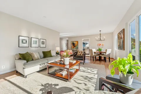 a spacious bedroom with a bed and wooden floor