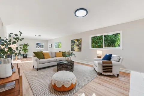 a view of a patio with table and chairs and potted plants