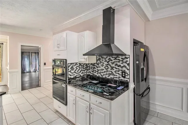 a kitchen with stainless steel appliances a refrigerator and a stove