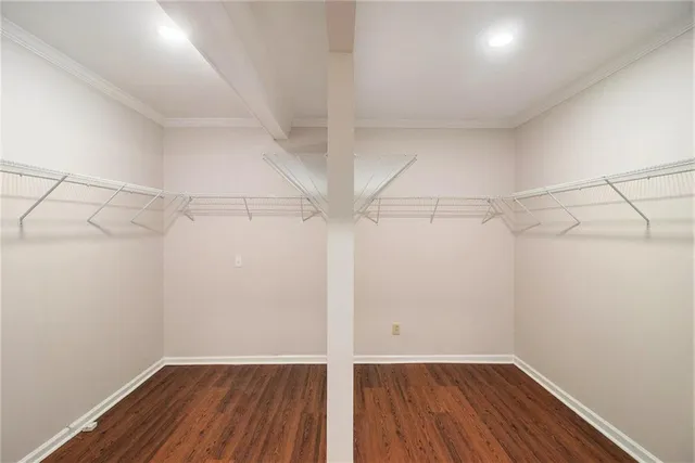 a view of a room with wooden floor