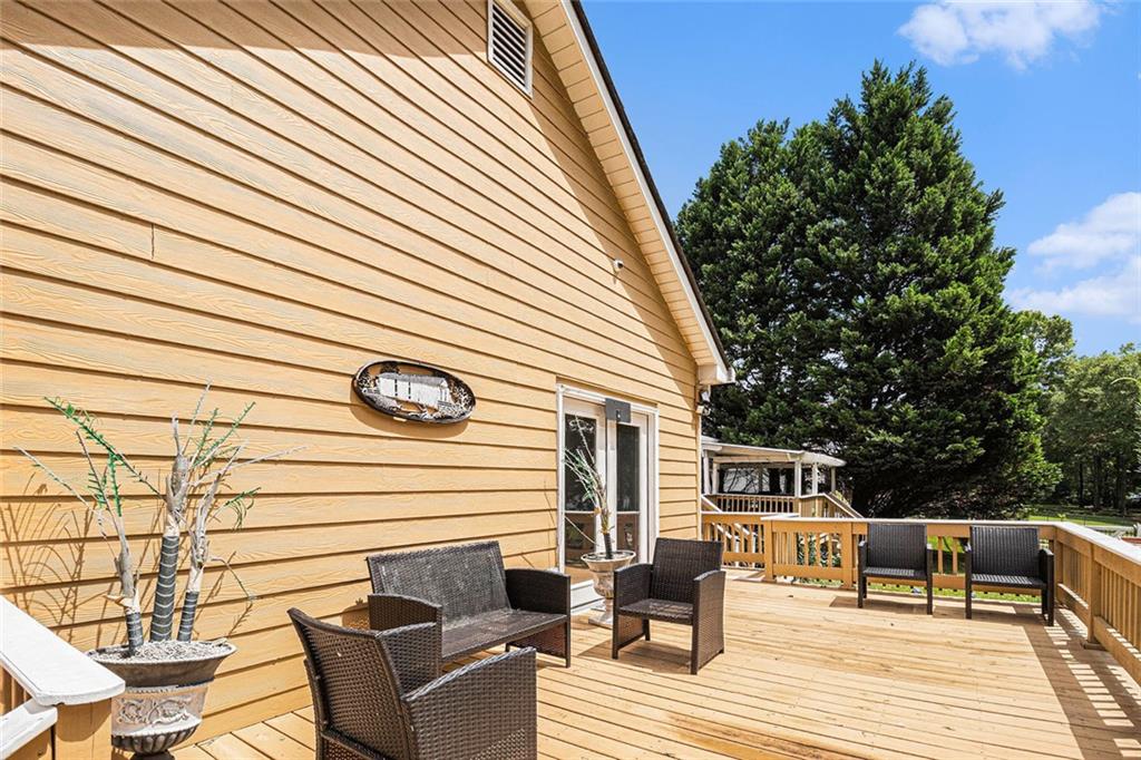 96 Pointe View Court Jackson, GA 30233 - Photo 23 of 36 a view of backyard with seating space and wooden floor