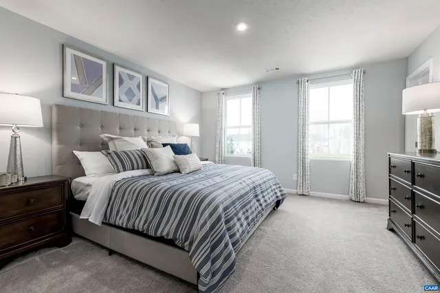 a spacious bedroom with a bed and a cabinets