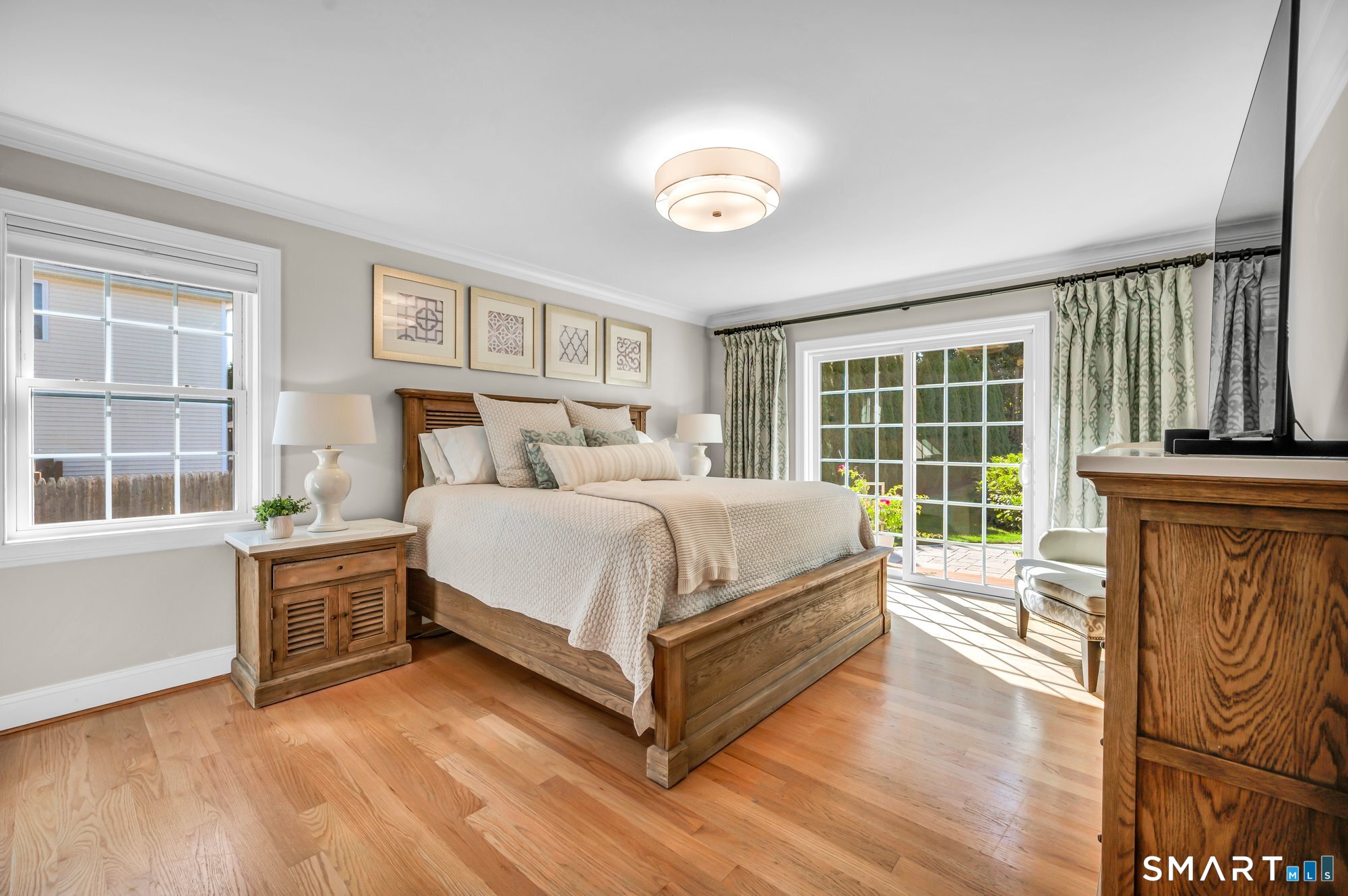 11 Grimes Road Rocky Hill, CT 06067 - Photo 14 of 40 Primary bedroom suite on main level. Hardwood floors, sliders that lead to outdoor patio. Primary bedroom has ensuite bathroom and walk in closet with custom shelving.