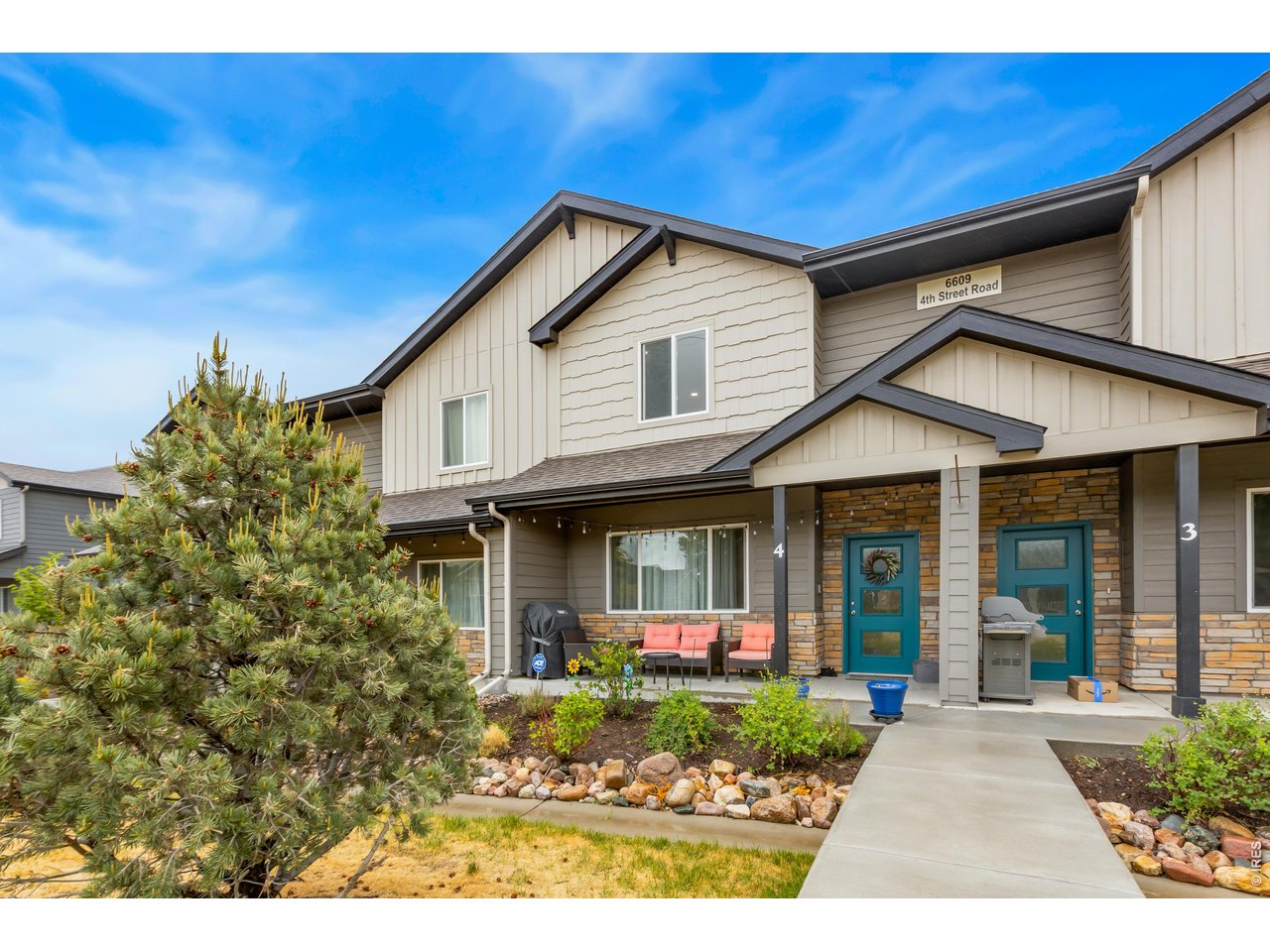 6609 4th St Road, Unit 4 Greeley, CO 80634 - Photo 3 of 41 a front view of a house with garden