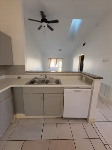 a kitchen with cabinets and white appliances