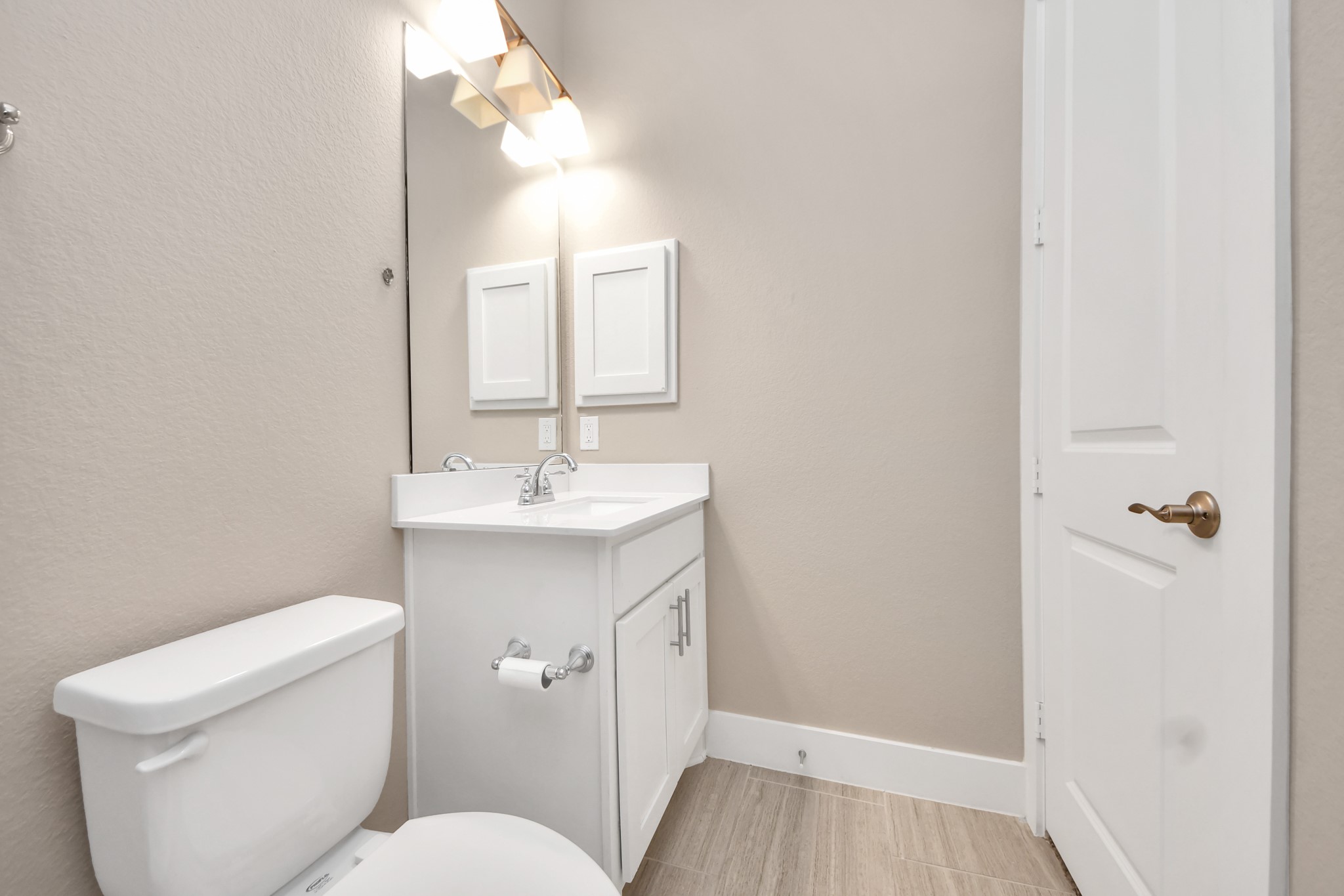 2704 Freund Street Houston, TX 77003 - Photo 8 of 45 a bathroom with a toilet a sink and mirror