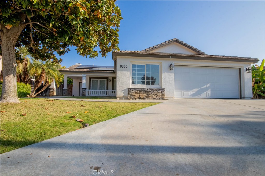 a front view of a house with garden