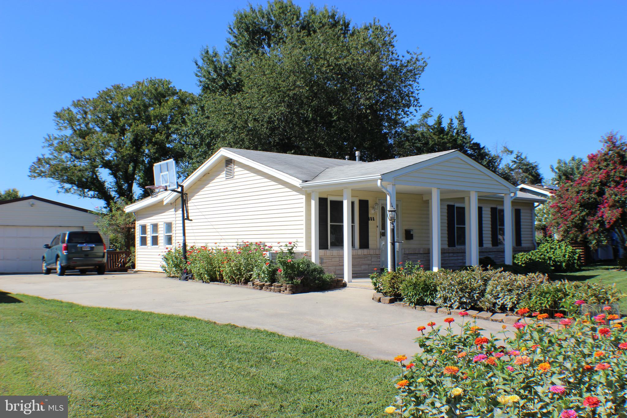 a view of a house with yard and a garden