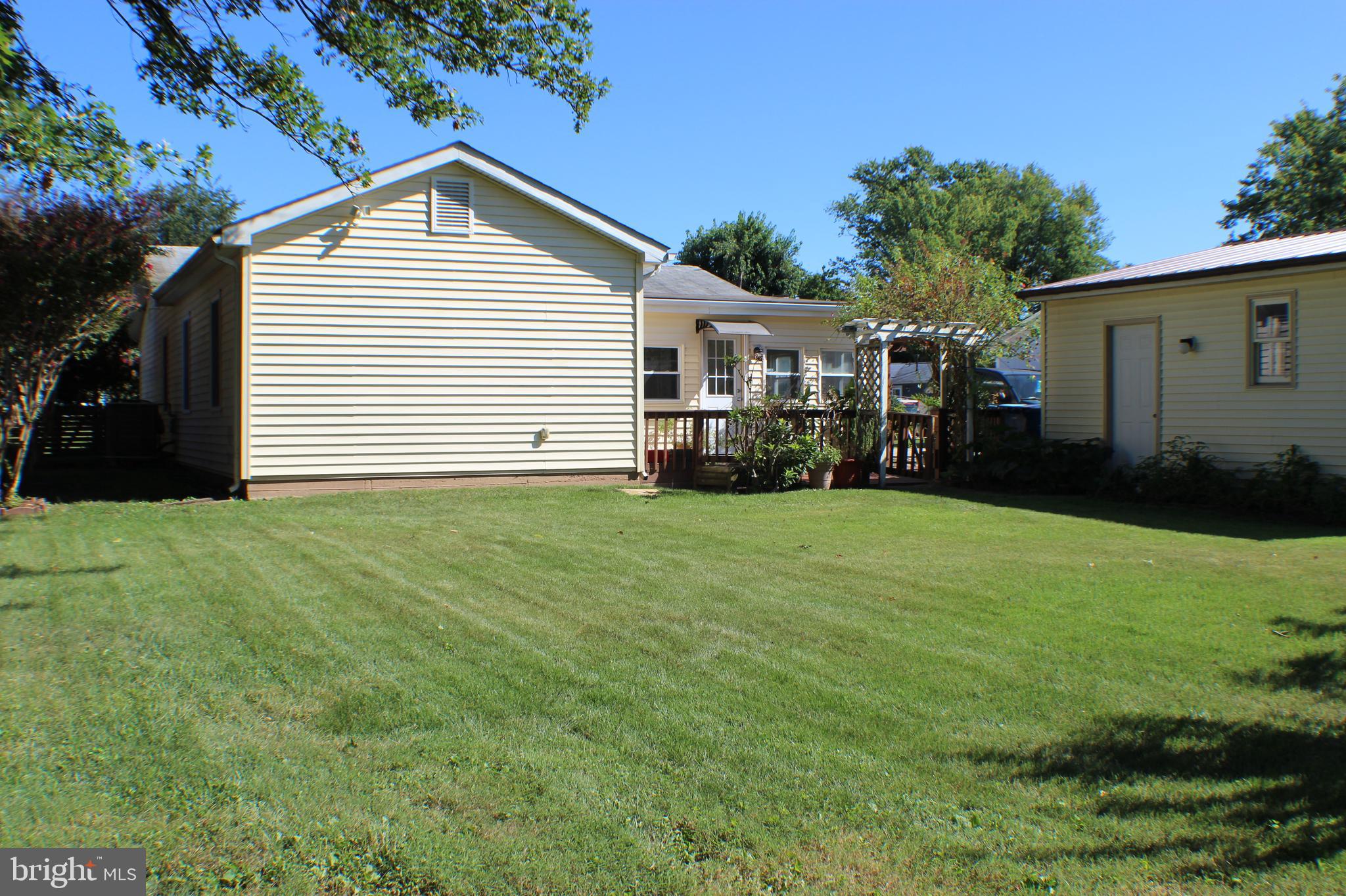 111 North Hickory Road Sterling, VA 20164 - Photo 12 of 30 a front view of a house with a garden and yard