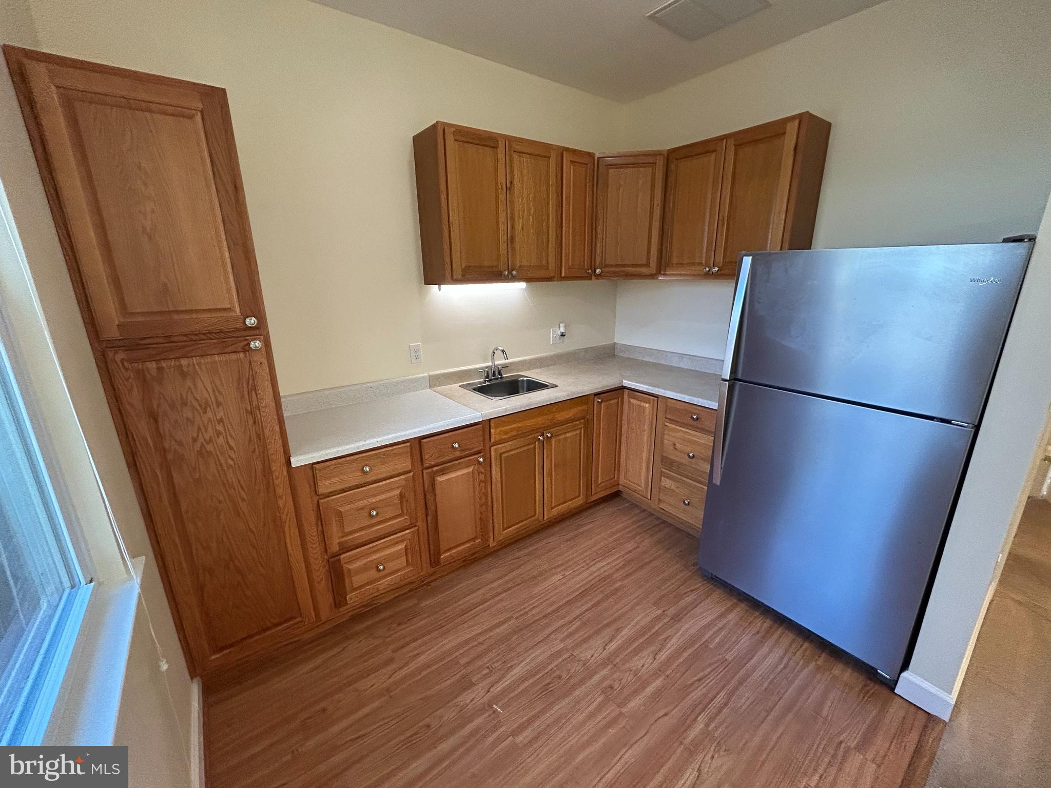 111 North Hickory Road Sterling, VA 20164 - Photo 27 of 30 a kitchen with a refrigerator a sink and cabinets