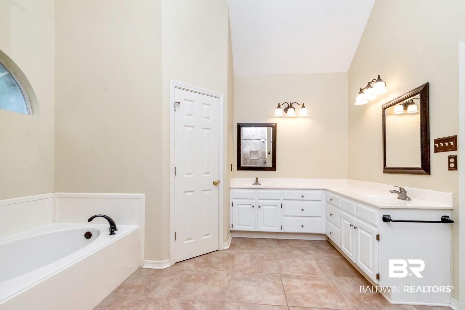 152 Ideal Avenue Mobile, AL 36608 - Photo 23 of 32 Bathroom with a bathtub, vanity, vaulted ceiling, and tile patterned flooring