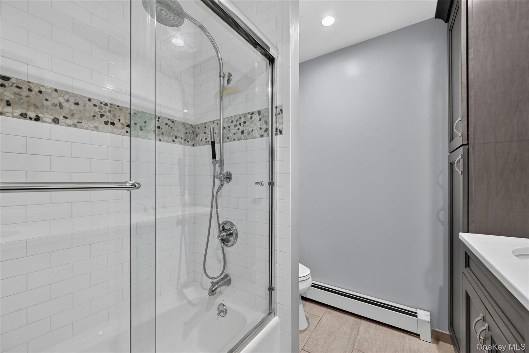 5 Hedges Road Warwick, NY 10990 - Photo 36 of 48 A glass-enclosed tub/shower with classic tile detail completes the updated hall bath serving the bedroom side of the home.