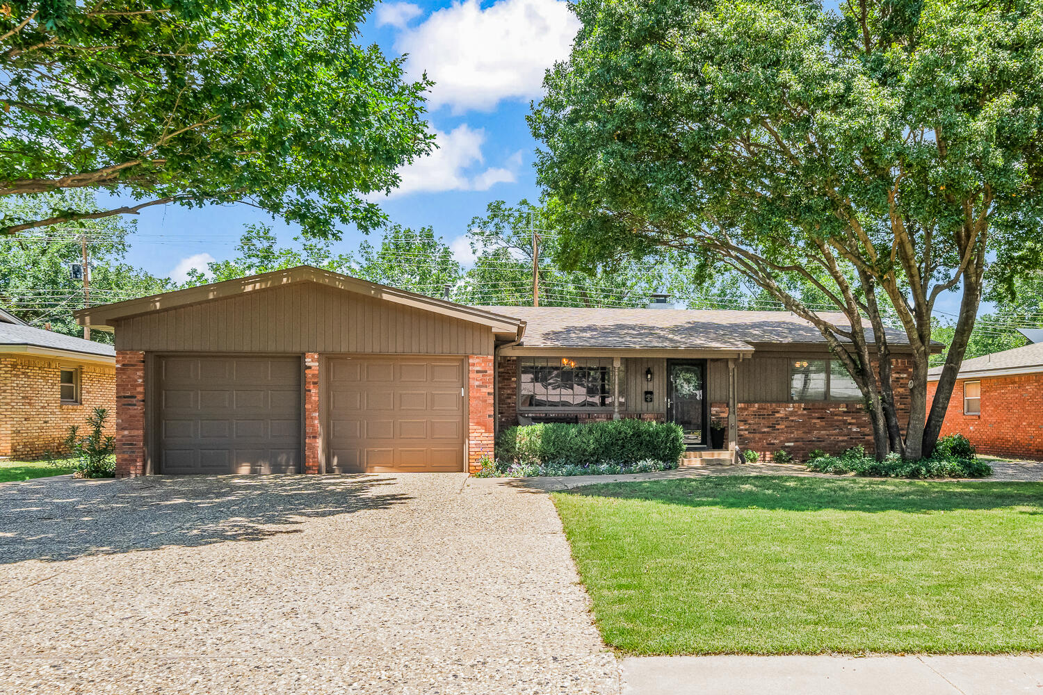 a front view of a house with a yard and a garage
