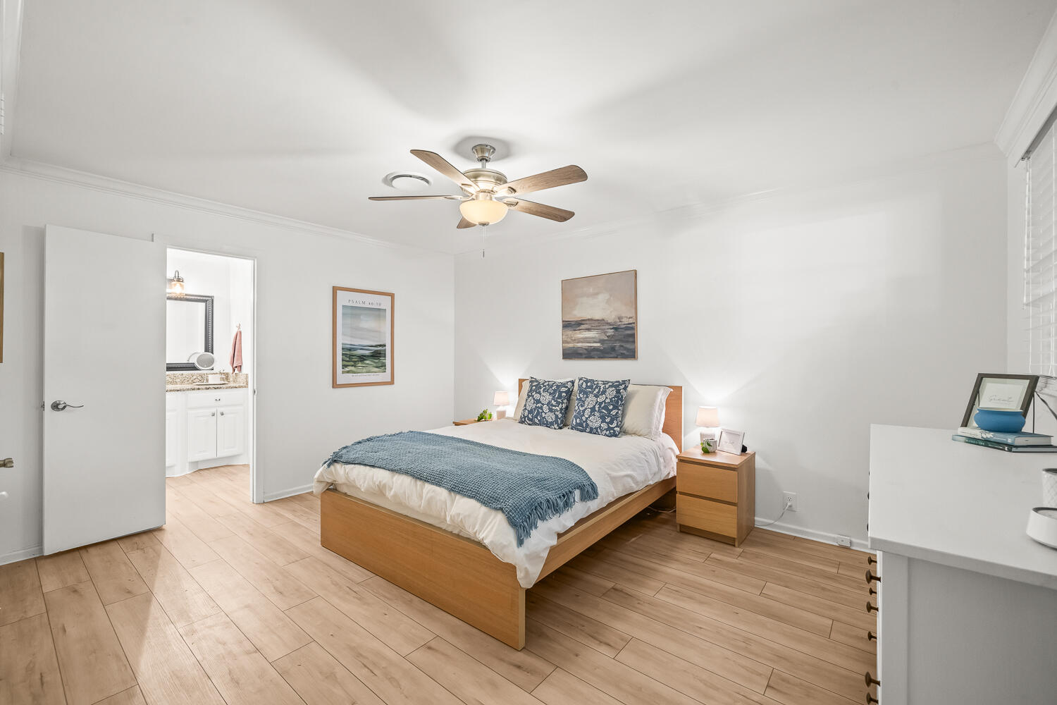3418 62nd Street Lubbock, TX 79413 - Photo 17 of 45 a spacious bedroom with a bed and a chandelier