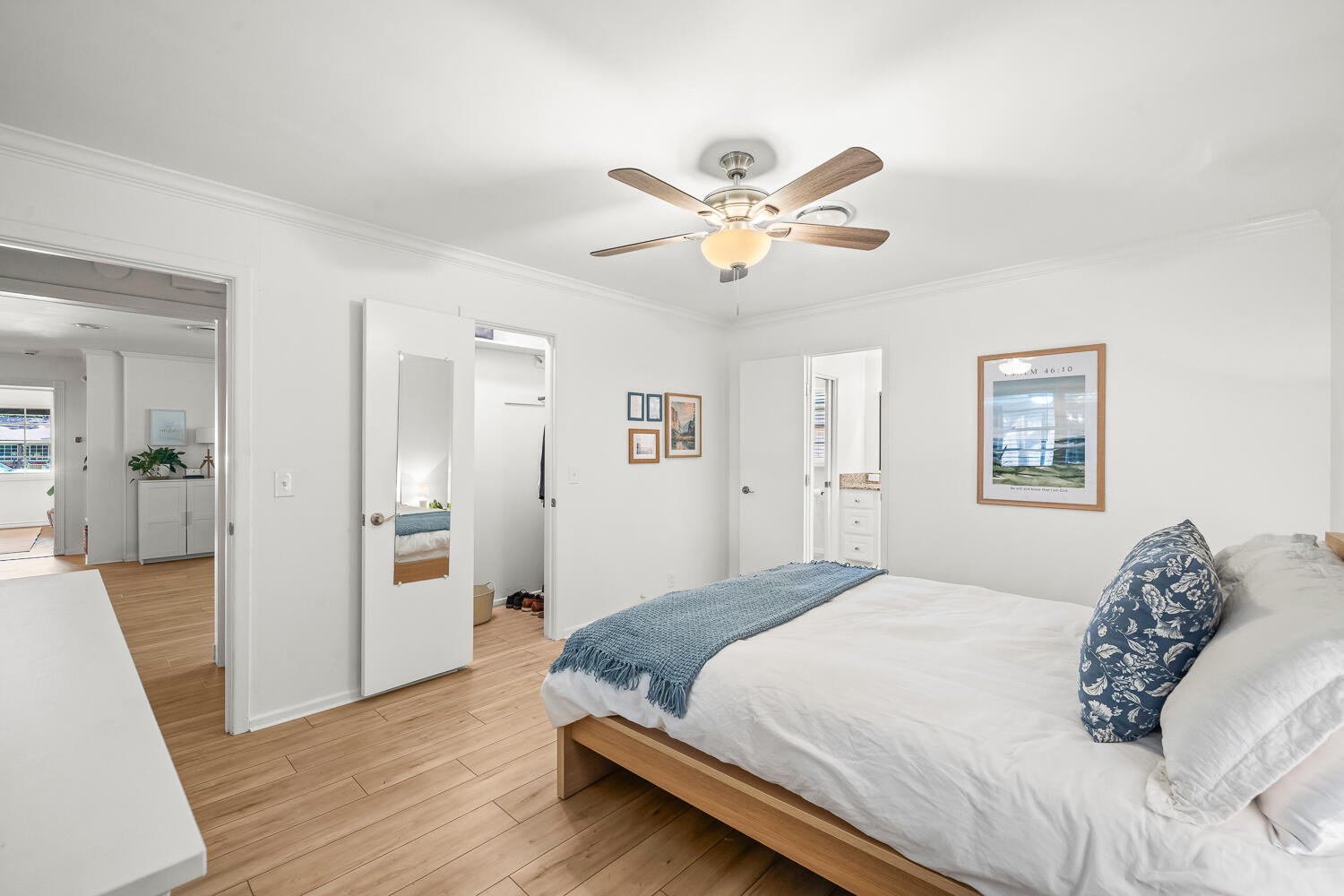 3418 62nd Street Lubbock, TX 79413 - Photo 20 of 45 a spacious bedroom with a bed and a chandelier