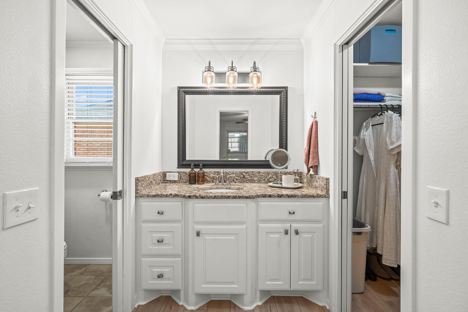 3418 62nd Street Lubbock, TX 79413 - Photo 21 of 45 a bathroom with a granite countertop sink and a mirror