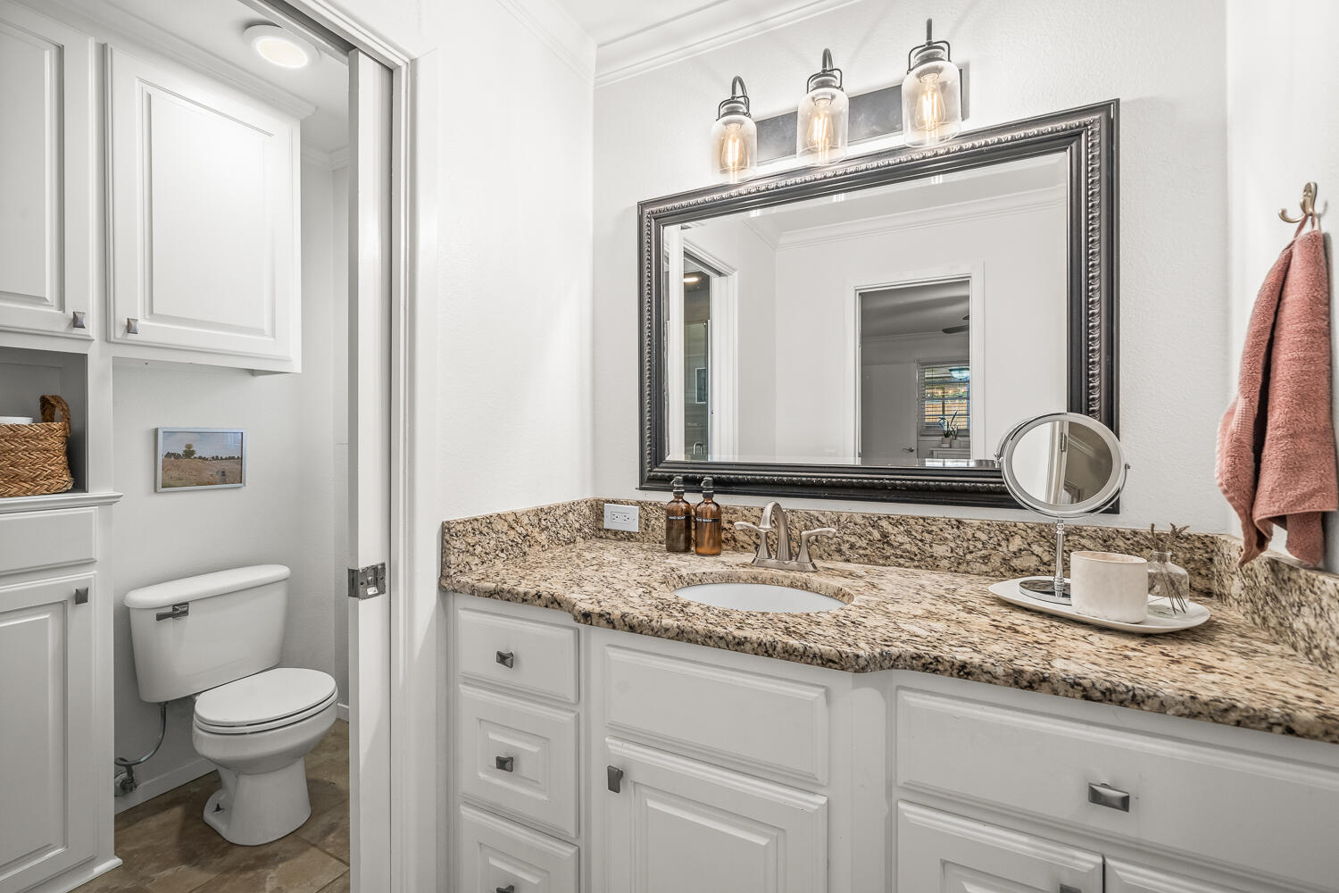 3418 62nd Street Lubbock, TX 79413 - Photo 22 of 45 a bathroom with a granite countertop sink vanity mirror and toilet