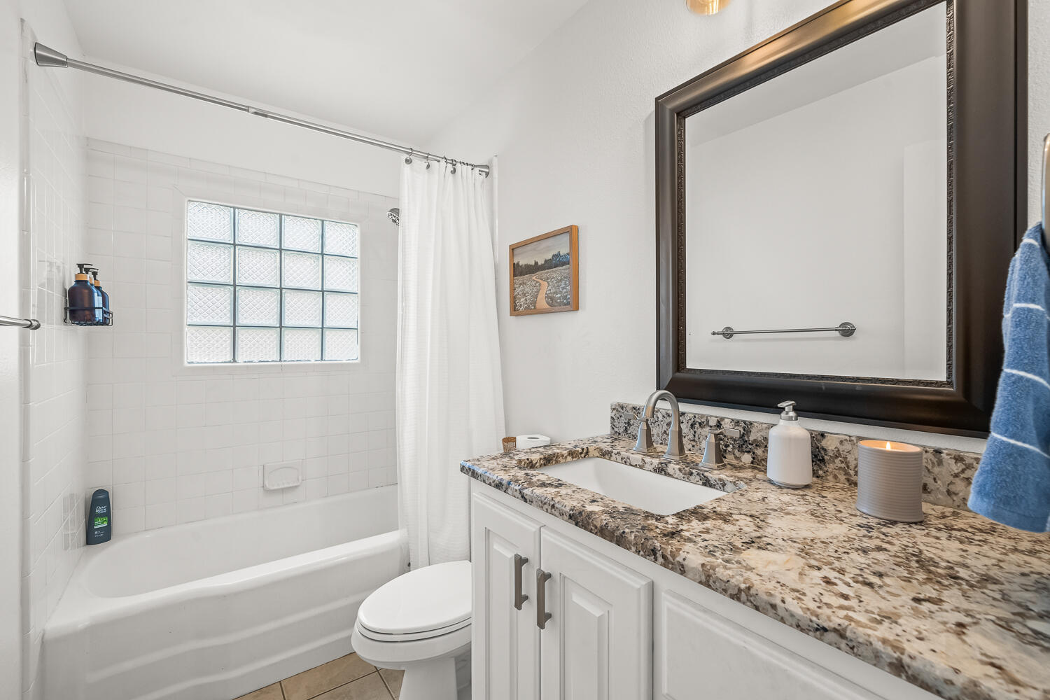 3418 62nd Street Lubbock, TX 79413 - Photo 27 of 45 a bathroom with a granite countertop sink toilet and shower