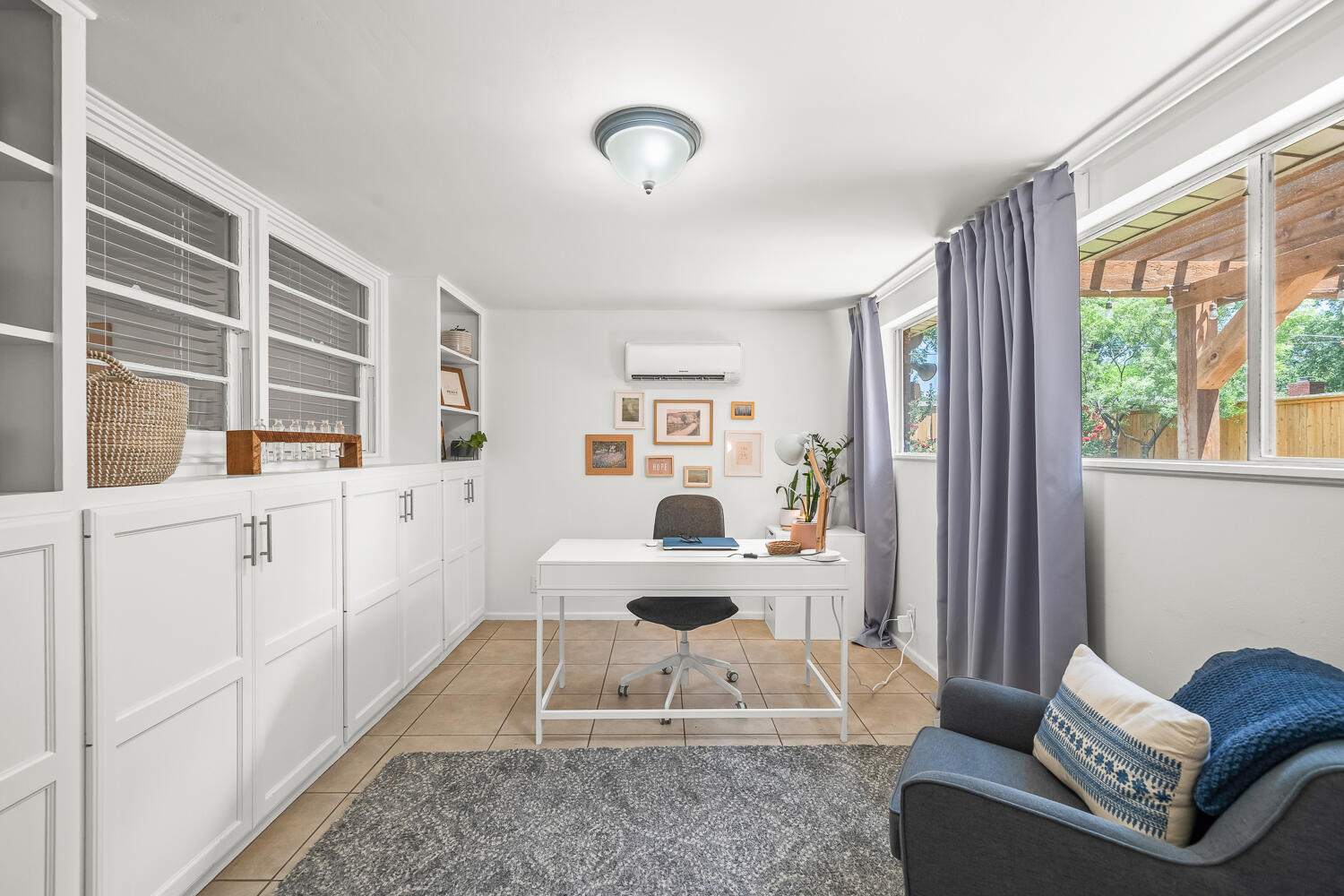 3418 62nd Street Lubbock, TX 79413 - Photo 32 of 45 a living room with furniture a flat screen tv and a window
