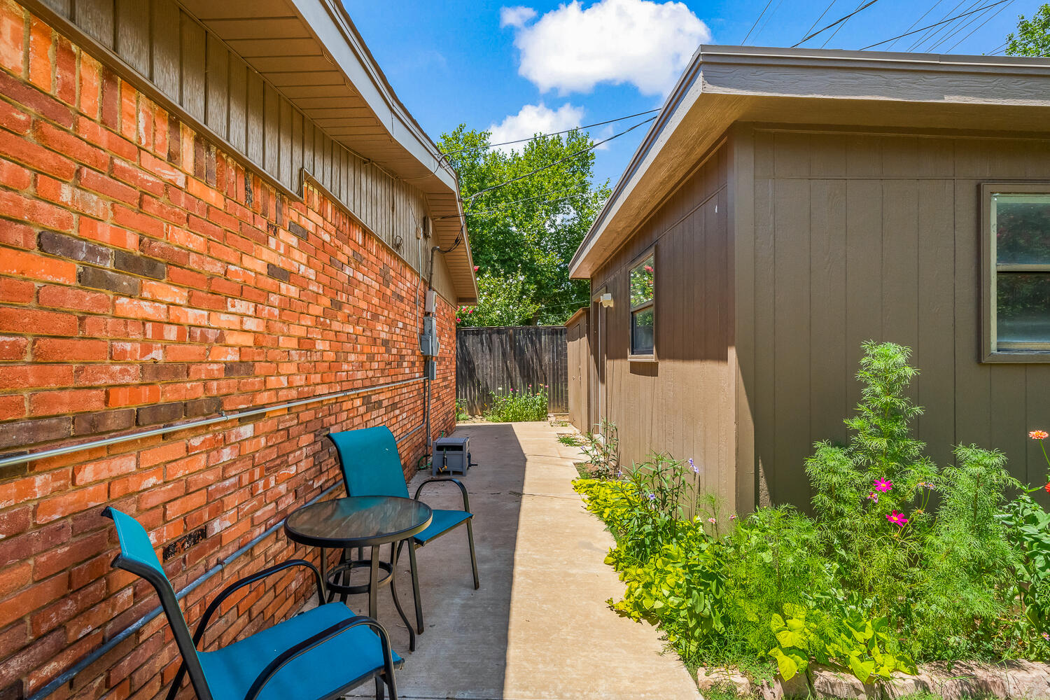 3418 62nd Street Lubbock, TX 79413 - Photo 41 of 45 a backyard of a house with table and chairs