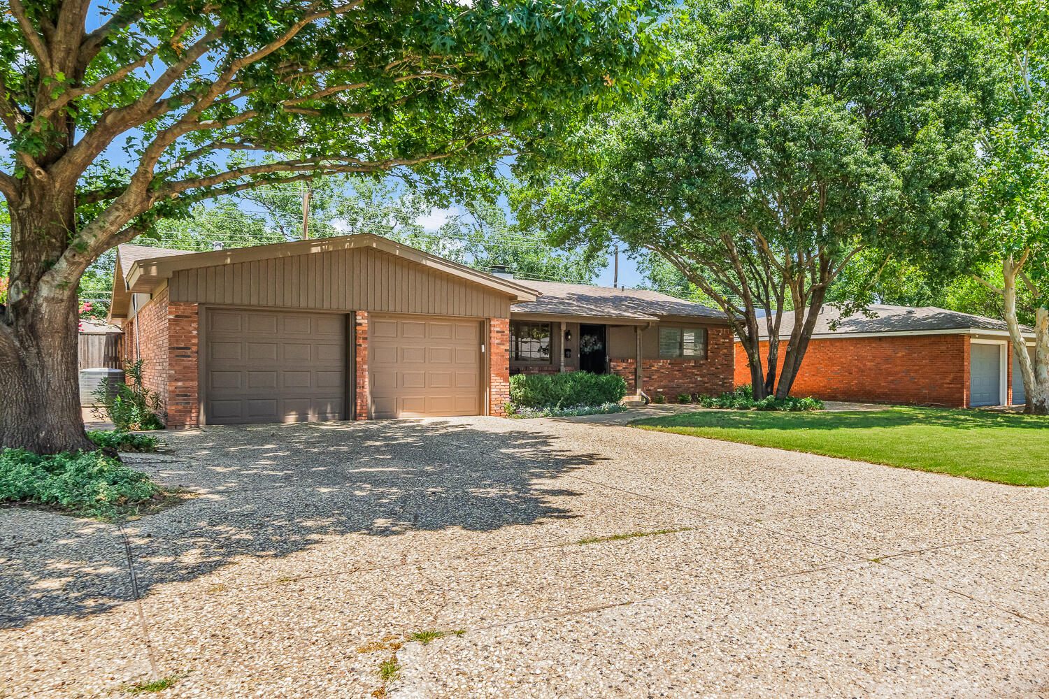3418 62nd Street Lubbock, TX 79413 - Photo 43 of 45 a front view of a house with a yard and garage