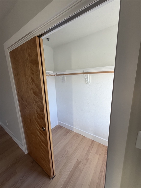 944 East Street, Unit 3 Walpole, MA 02081 - Photo 16 of 23 an empty room with wooden floor and entrance