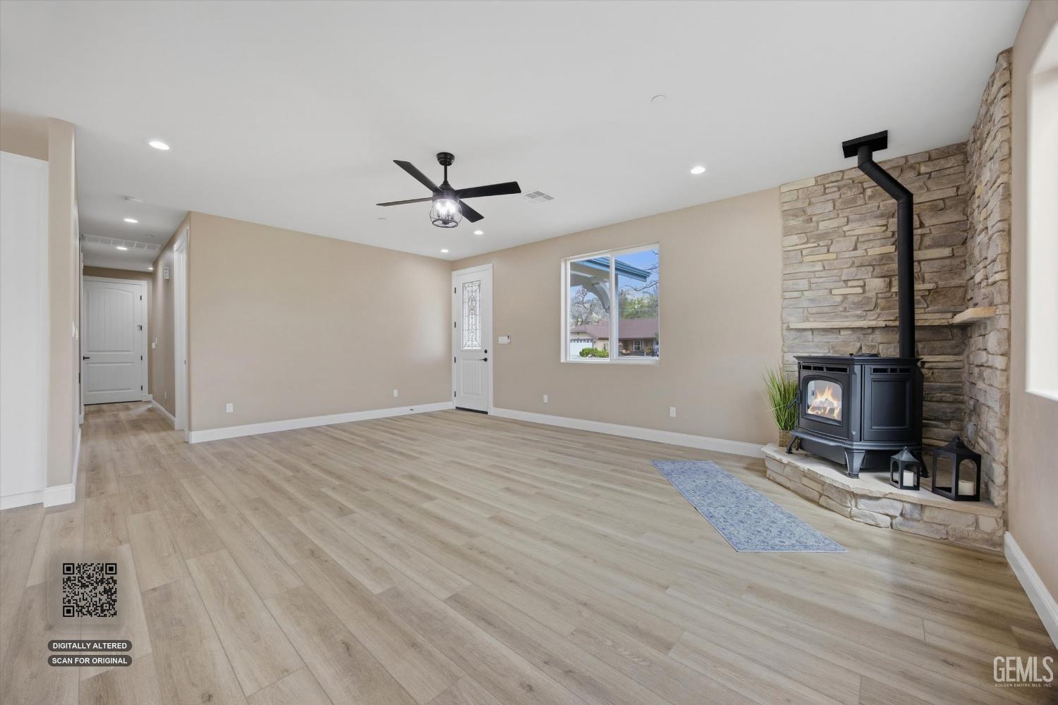 Undisclosed Address Tehachapi, CA 93561 - Photo 15 of 47 a view of livingroom with hardwood floor and a fireplace